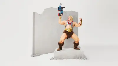 He-Man wielding the Bosch 18V Bulldog Rotary Hammer, showcasing its power and durability. The gladiator stands beside a shattered wall, symbolizing the tool's ability to handle the toughest tasks.