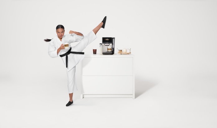 The Bosch 800 Series Fully Automatic Espresso Machine is accompanied by a martial artist performing a precise high kick. The scene emphasizes balance, precision, and quality